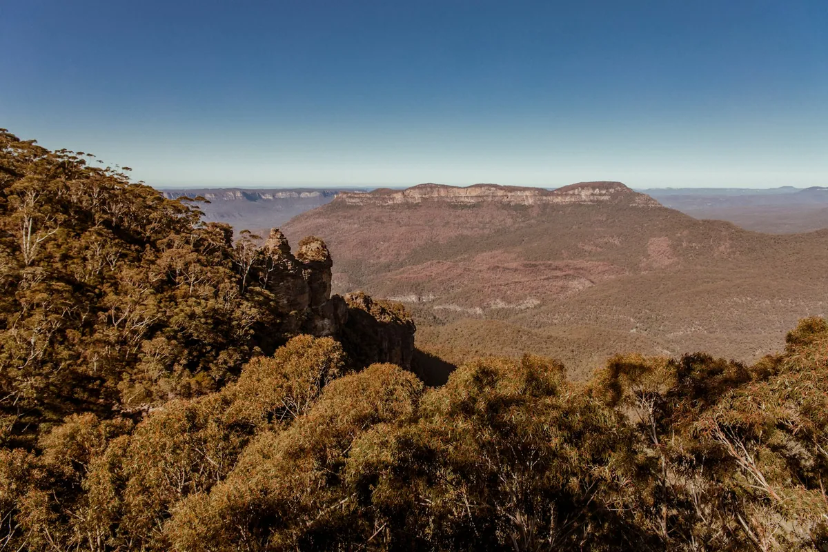 The Three Sisters rock formation lit by sunlight in the Blue Mountains, NSW