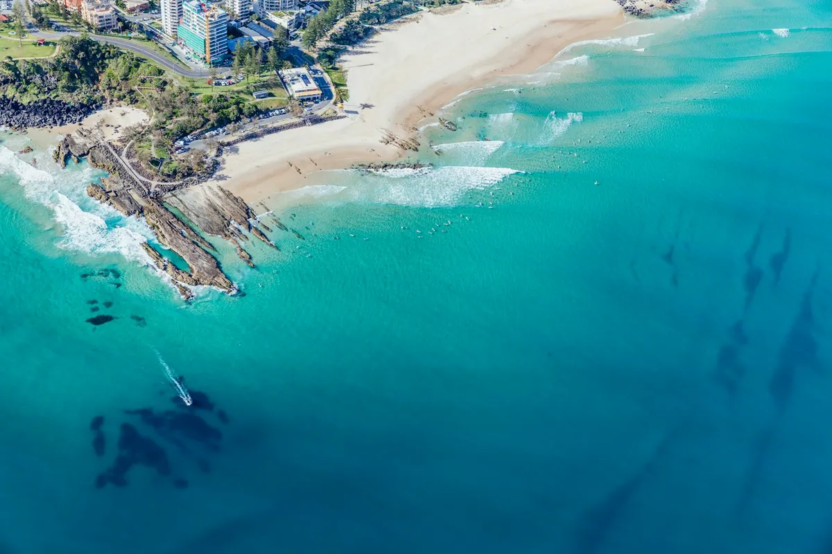 Surfers riding waves at Snapper Rocks, Coolangatta on the southern Gold Coast