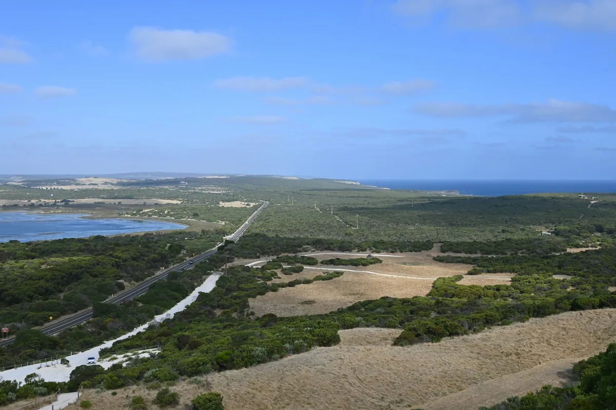 Aerial view of a coastal road winding past the water near Penneshaw, Kangaroo Island