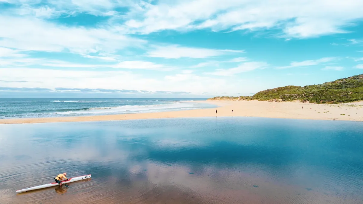A surfer paddling out at the Margaret River mouth in south-west Western Australia
