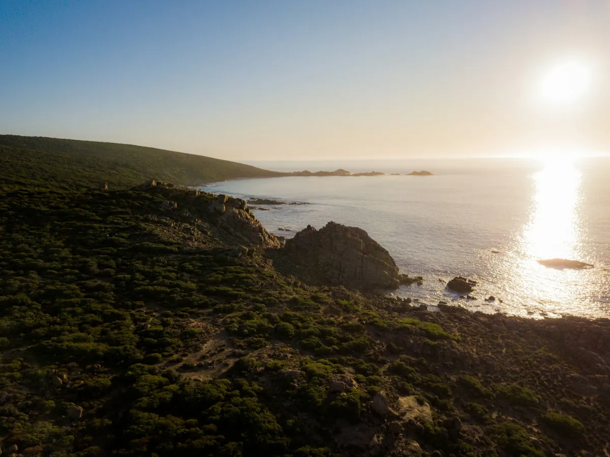 Aerial view of grass-covered headland meeting the Indian Ocean in the Margaret River region