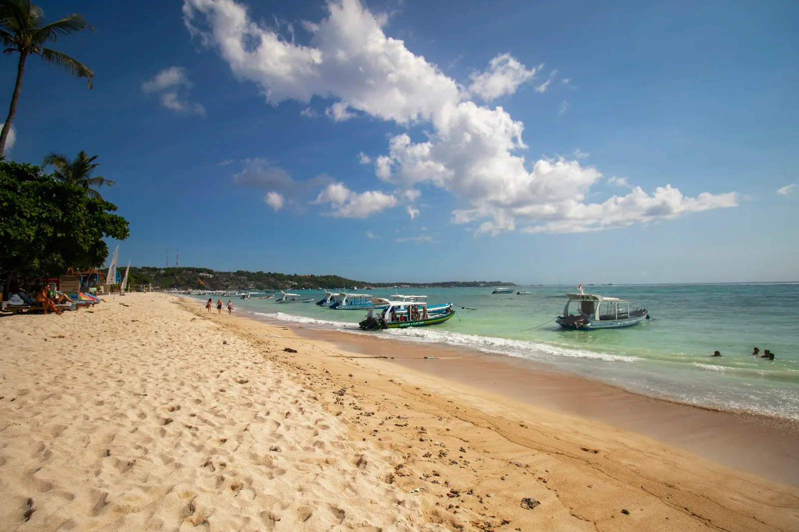 Traditional white and black boat moored on Nusa Lembongan shoreline, Bali