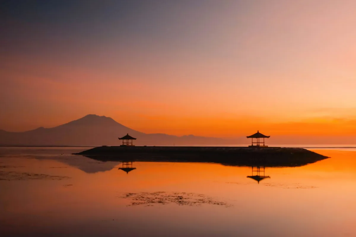 Sunrise over Sanur Beach with mountain backdrop, Bali, Indonesia