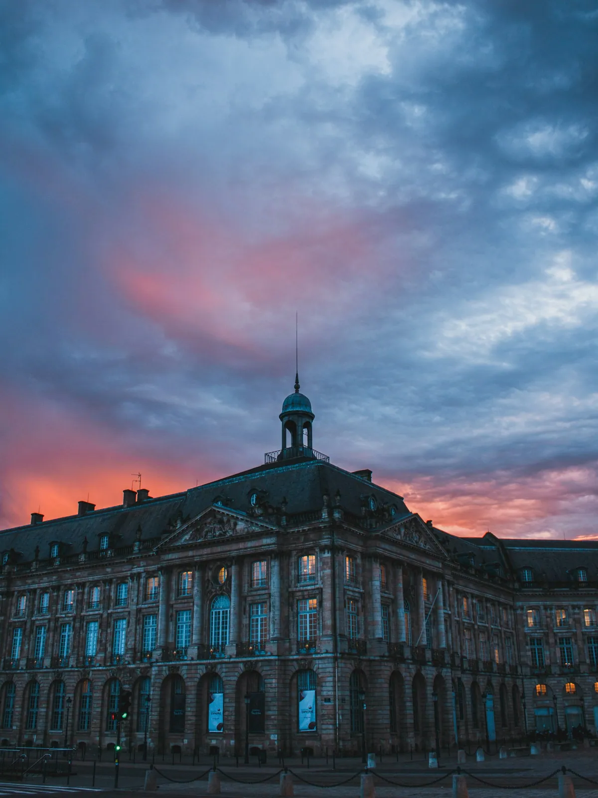 Facade of Place de la Bourse glowing in golden hour, Bordeaux