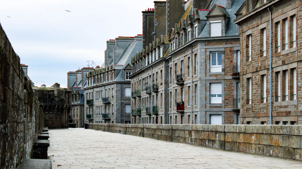 Cobblestone street lined with stone buildings inside the walls of Saint-Malo