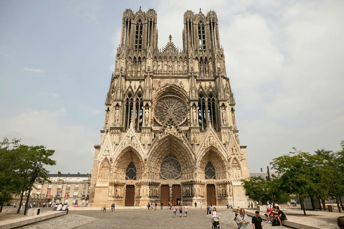 Pedestrians on the square in front of Reims Cathedral