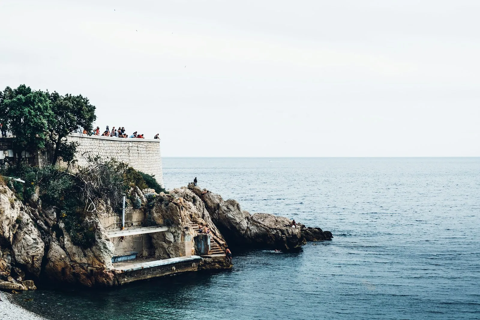 Stony shoreline and platform along the Promenade des Anglais in Nice
