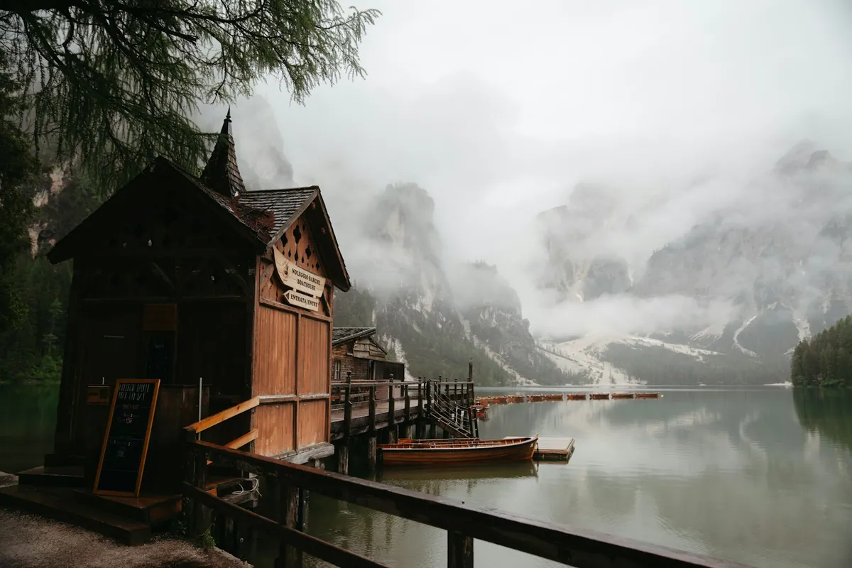 Boat dock on Lago di Braies with Dolomites mountains behind