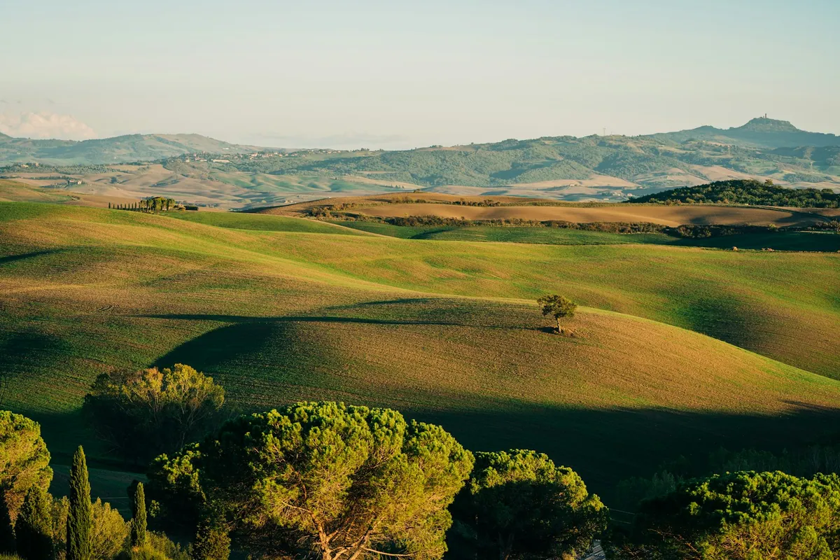 Tuscan landscape with hills around San Quirico dOrcia in autumn
