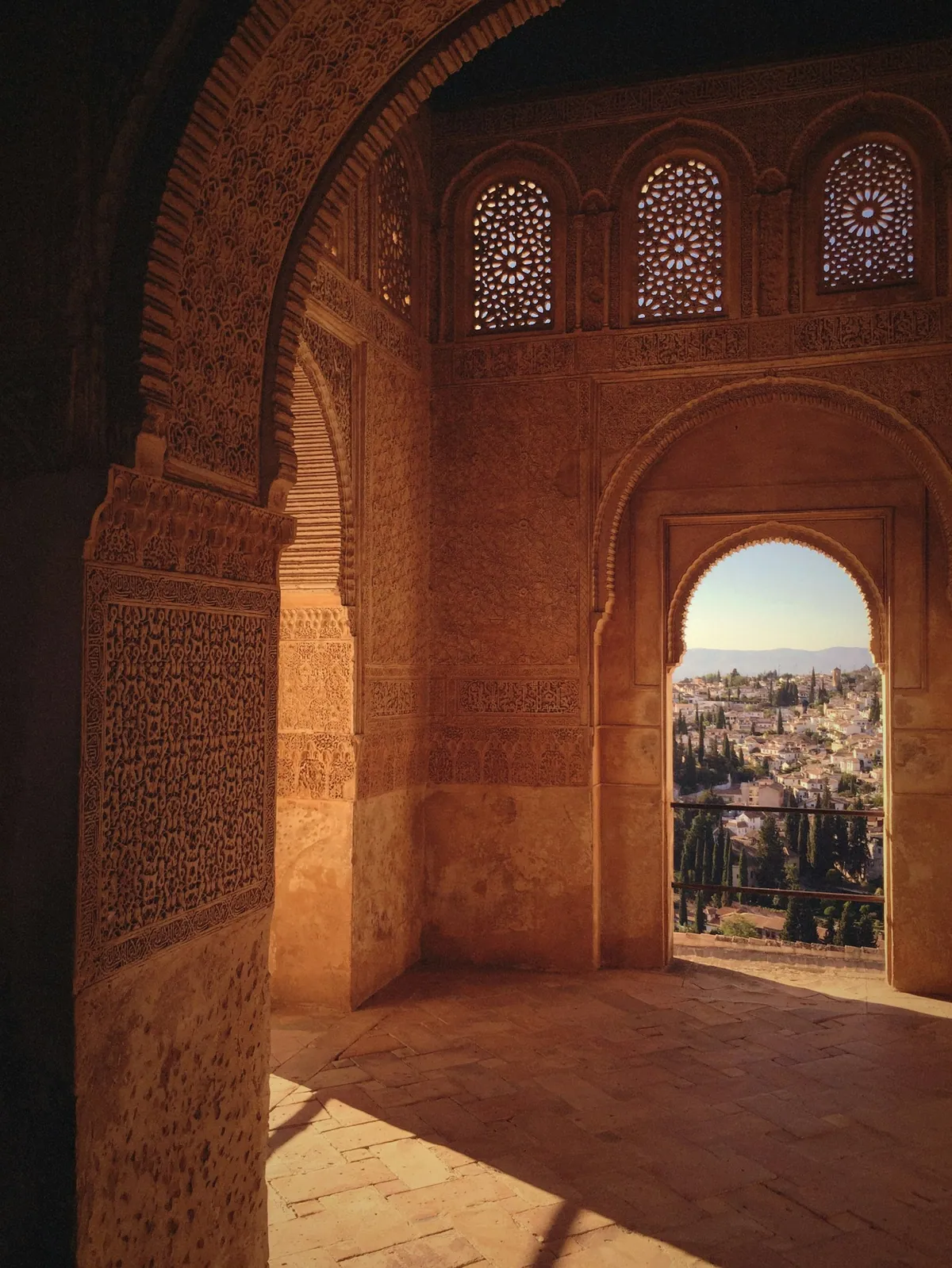 View of Granada framed through an arch at the Alhambra